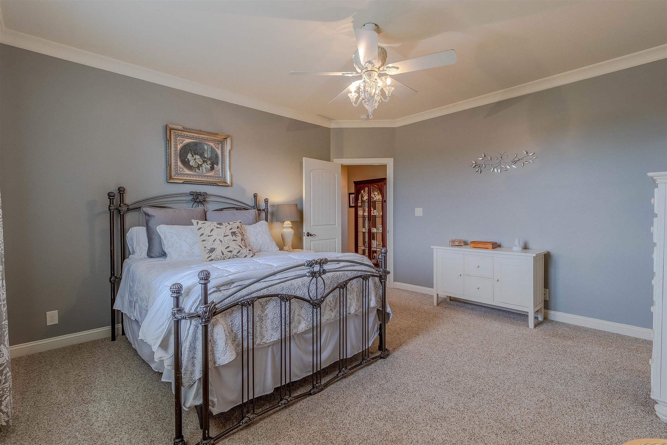2687 Gunn Road Adams, TN 37010 - Photo 17 of 30 a bedroom with a bed and a chandelier