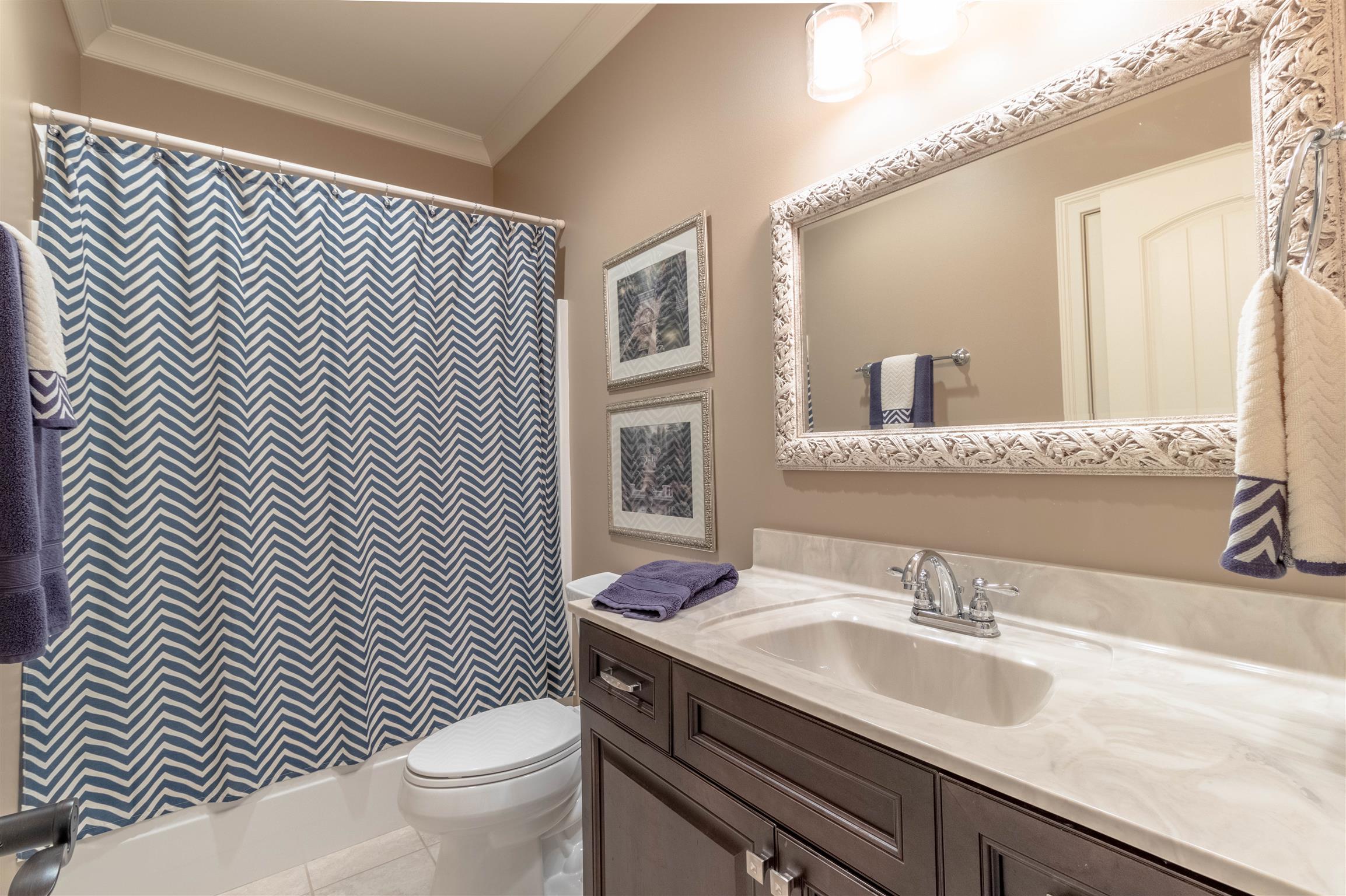 2687 Gunn Road Adams, TN 37010 - Photo 21 of 30 a bathroom with a toilet a sink and a large mirror