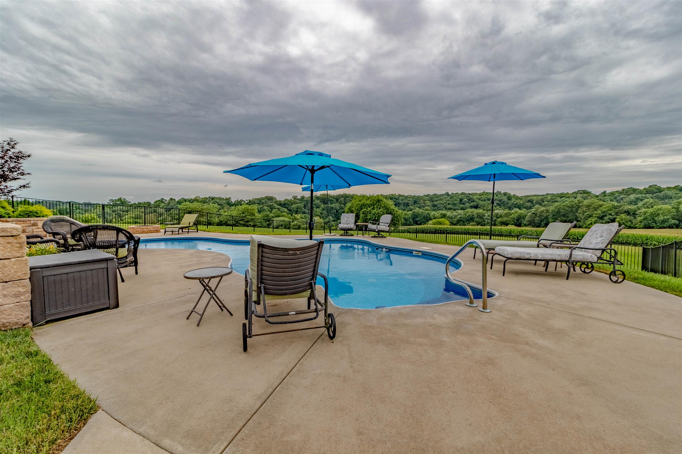 2687 Gunn Road Adams, TN 37010 - Photo 26 of 30 a view of a chairs and table under an umbrella