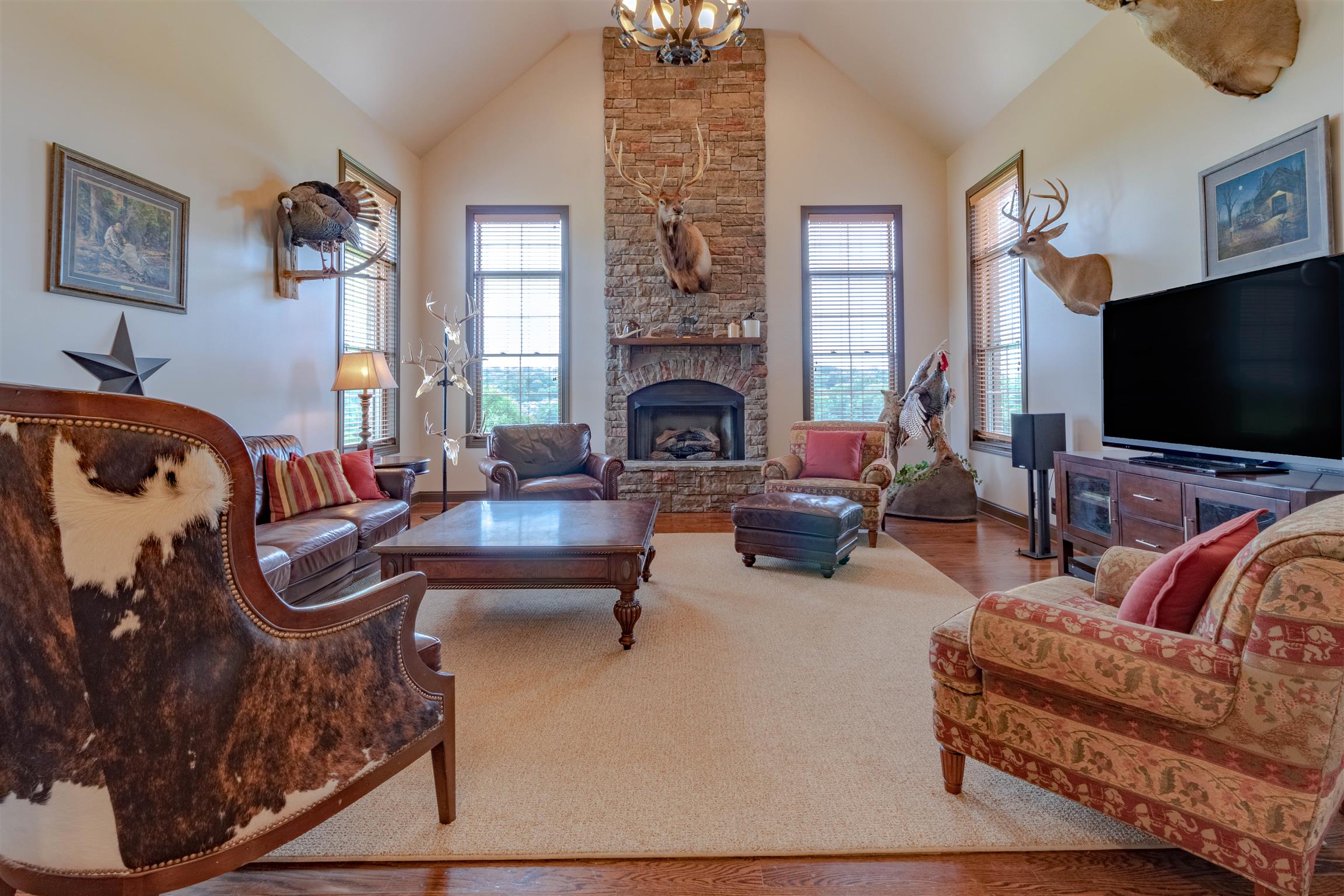 2687 Gunn Road Adams, TN 37010 - Photo 7 of 30 a living room with furniture a flat screen tv and a fireplace
