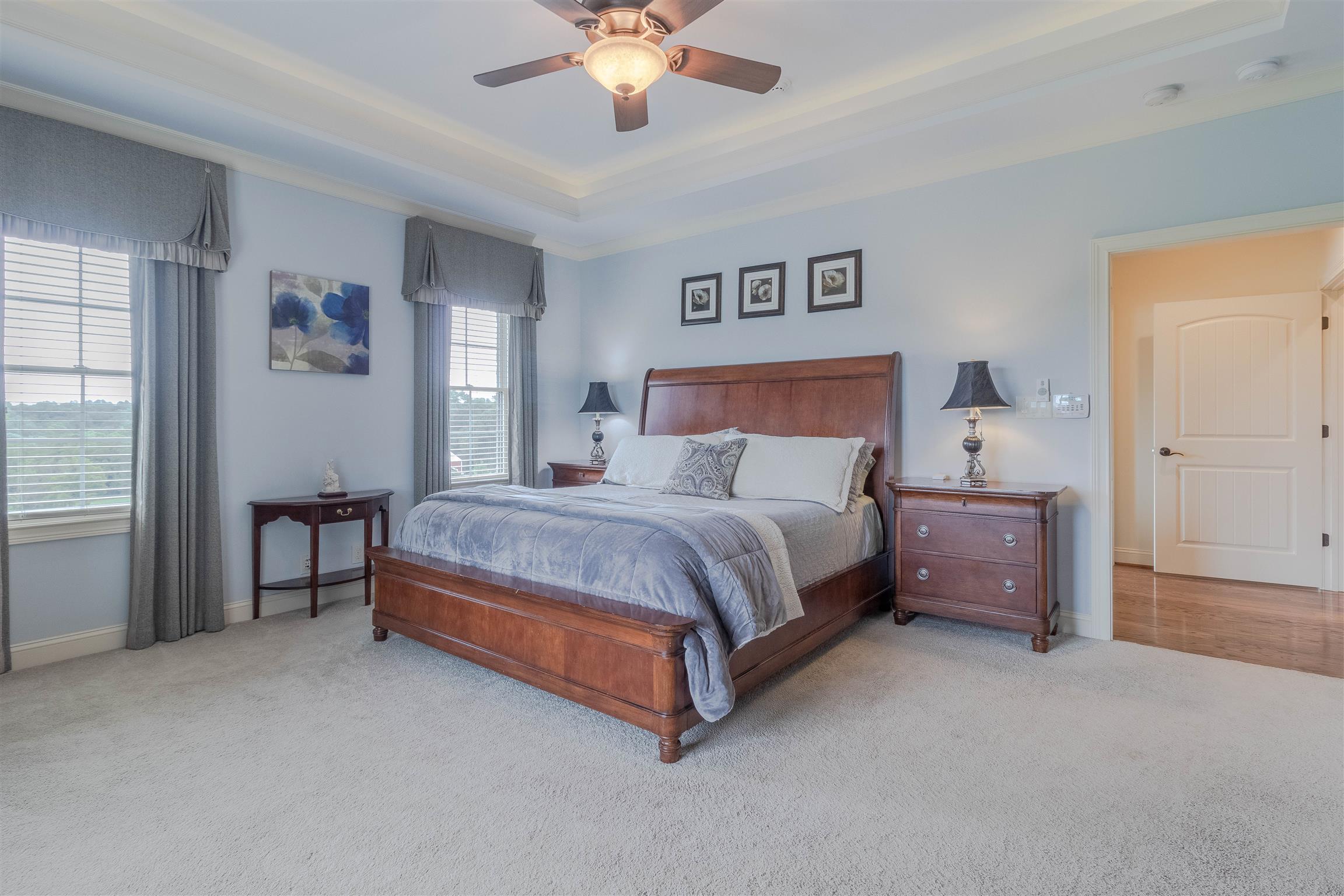 2687 Gunn Road Adams, TN 37010 - Photo 10 of 30 a bedroom with a bed and a chandelier