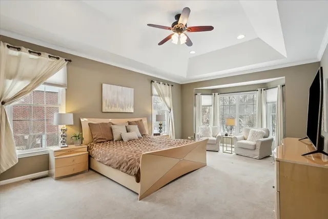 a bedroom with a bed couch and window