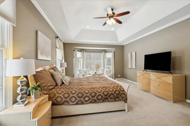 a bedroom with a large bed and a flat screen tv on the dresser