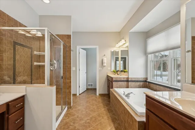 a large white kitchen with a large window and stainless steel appliances