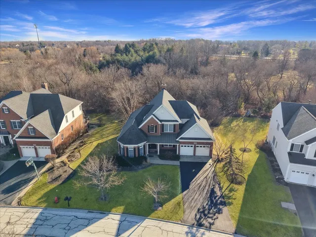 a aerial view of a house next to a yard