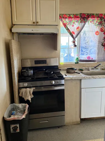 a kitchen with stainless steel appliances granite countertop a stove and a microwave
