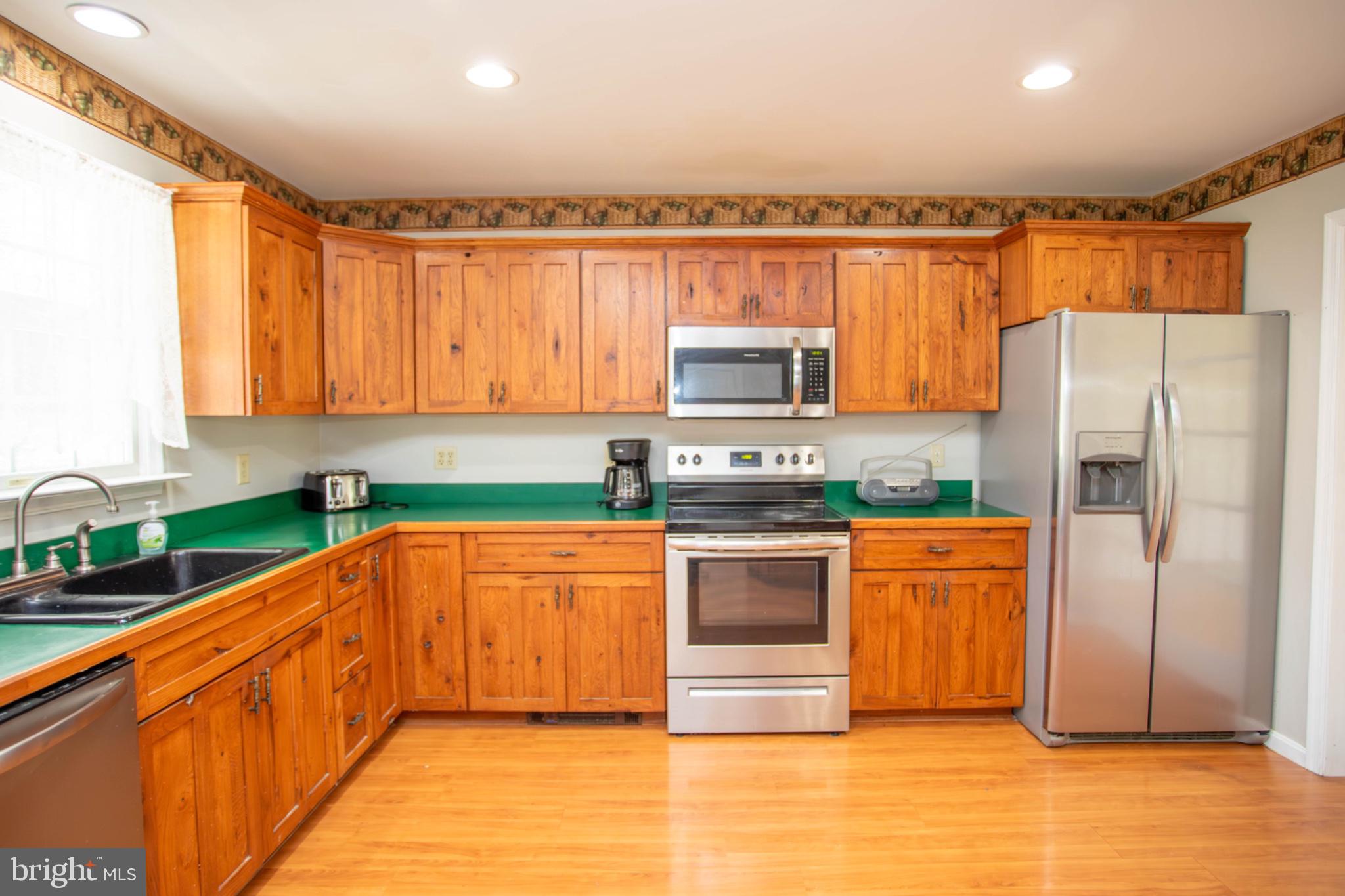 161 Coyote Run Mathias, WV 26812 - Photo 17 of 88 Warm wood tones in a cozy kitchen.