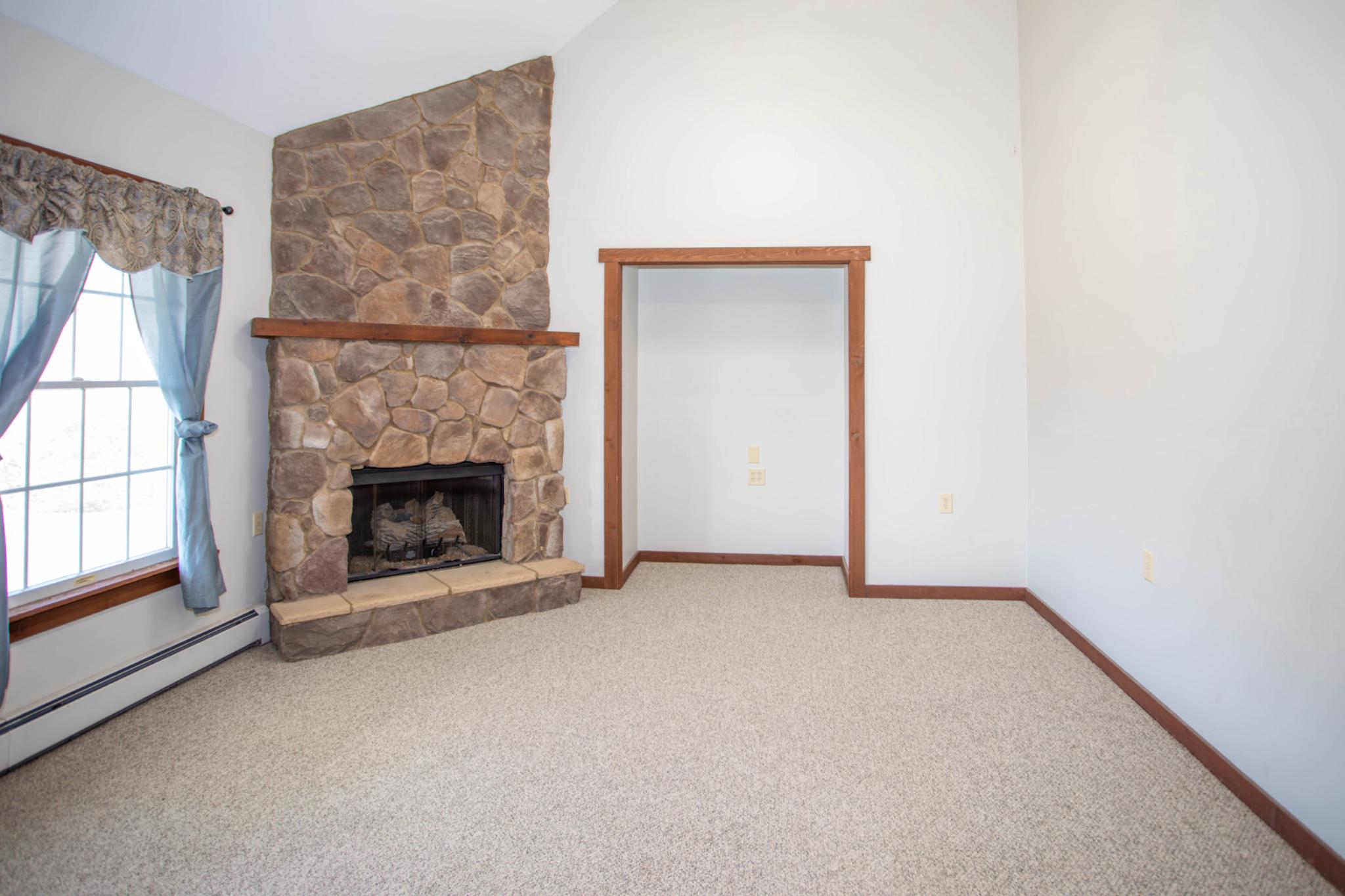 161 Coyote Run Mathias, WV 26812 - Photo 27 of 88 Cozy living room with stone fireplace.