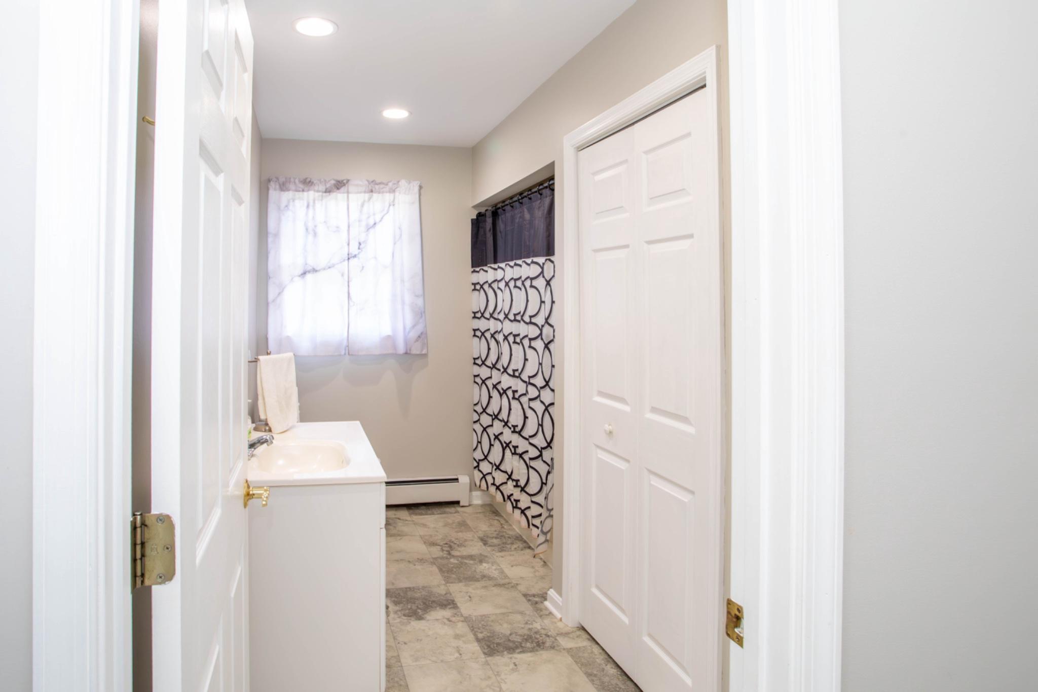 161 Coyote Run Mathias, WV 26812 - Photo 41 of 88 Bright and airy entry level bathroom entrance.