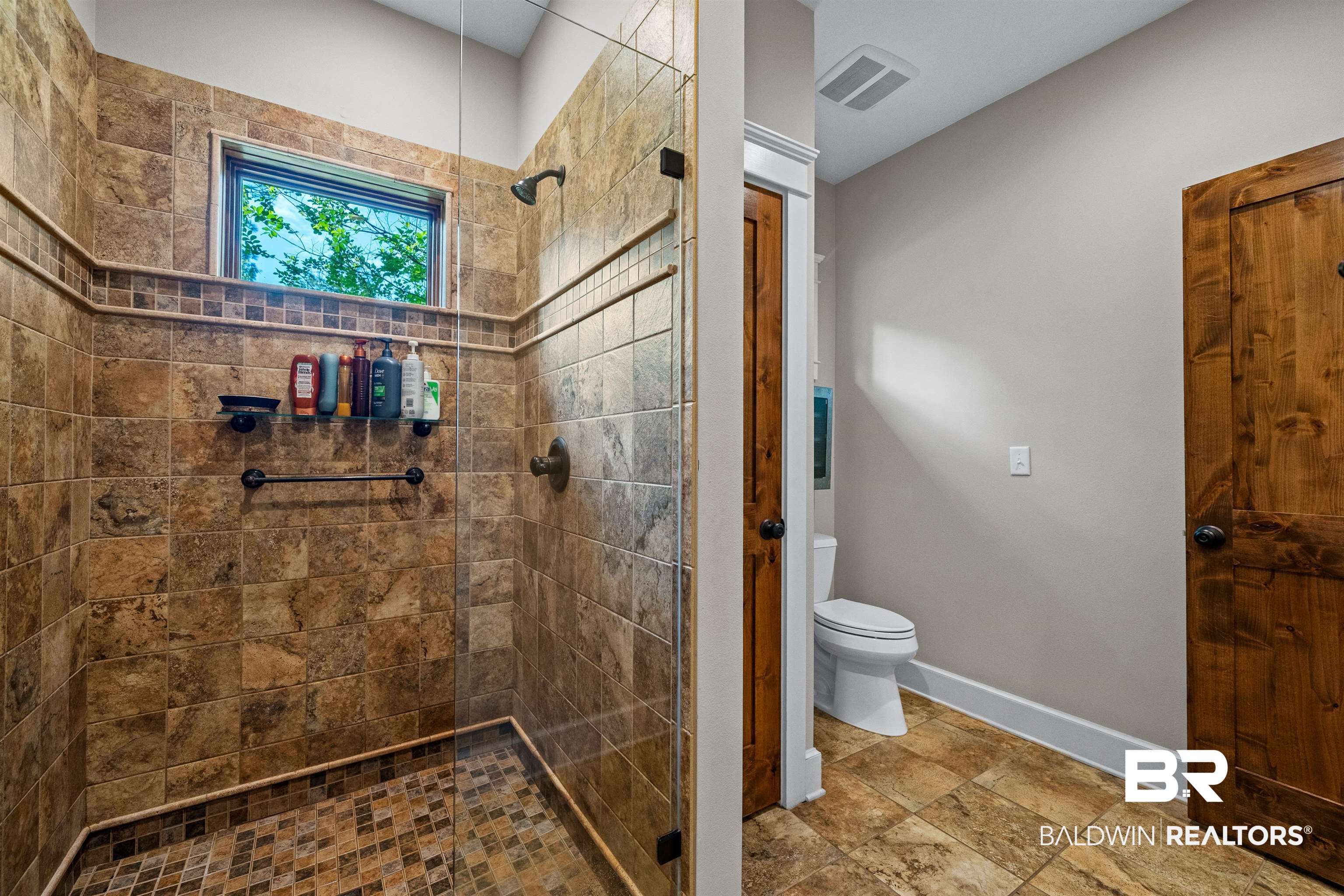 47252 Emmons Road Bay Minette, AL 36507 - Photo 30 of 50 Bathroom featuring a tile shower and stone finish flooring