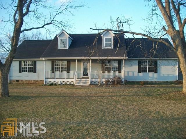 1197 Leguin Mill Road Locust Grove, GA 30248 - Photo 1 of 1 a front view of a house with a garden