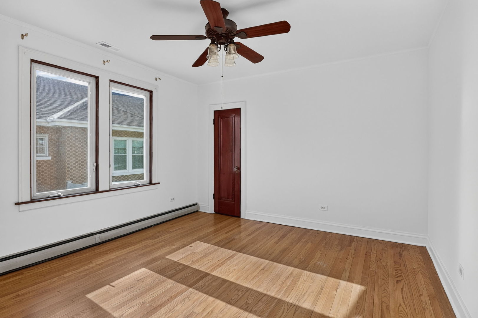 708 McCarthy Road Lemont, IL 60439 - Photo 10 of 14 a view of an empty room with wooden floor and a window