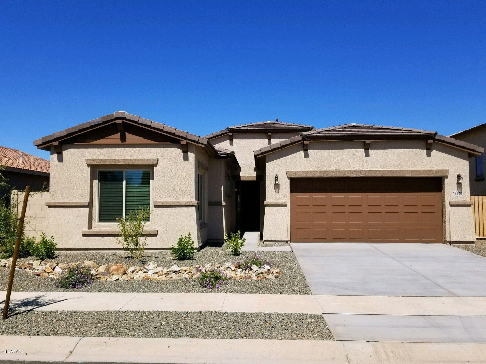 16746 West Rowel Road Surprise, AZ 85387 - Photo 1 of 35 a front view of a house with a yard and garage