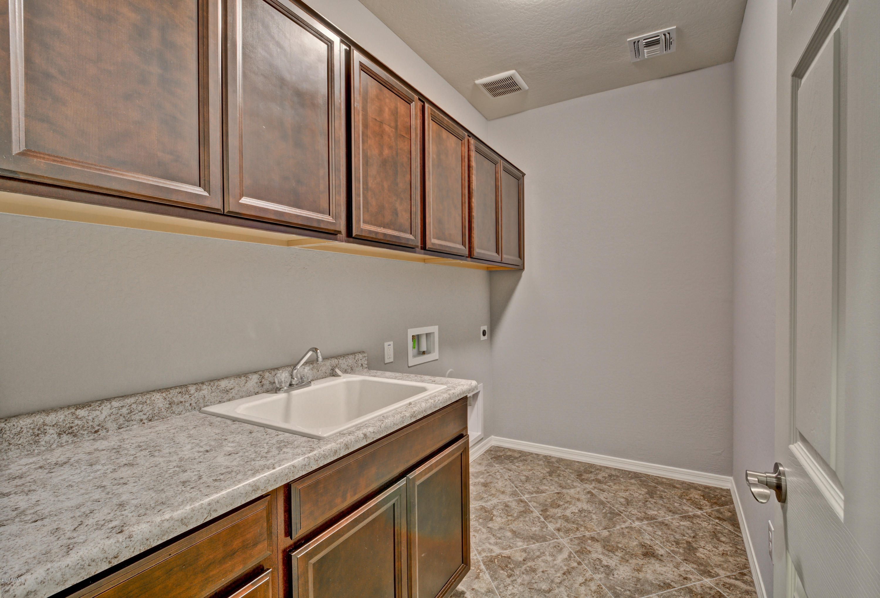 16746 West Rowel Road Surprise, AZ 85387 - Photo 11 of 35 a bathroom with a sink and a mirror