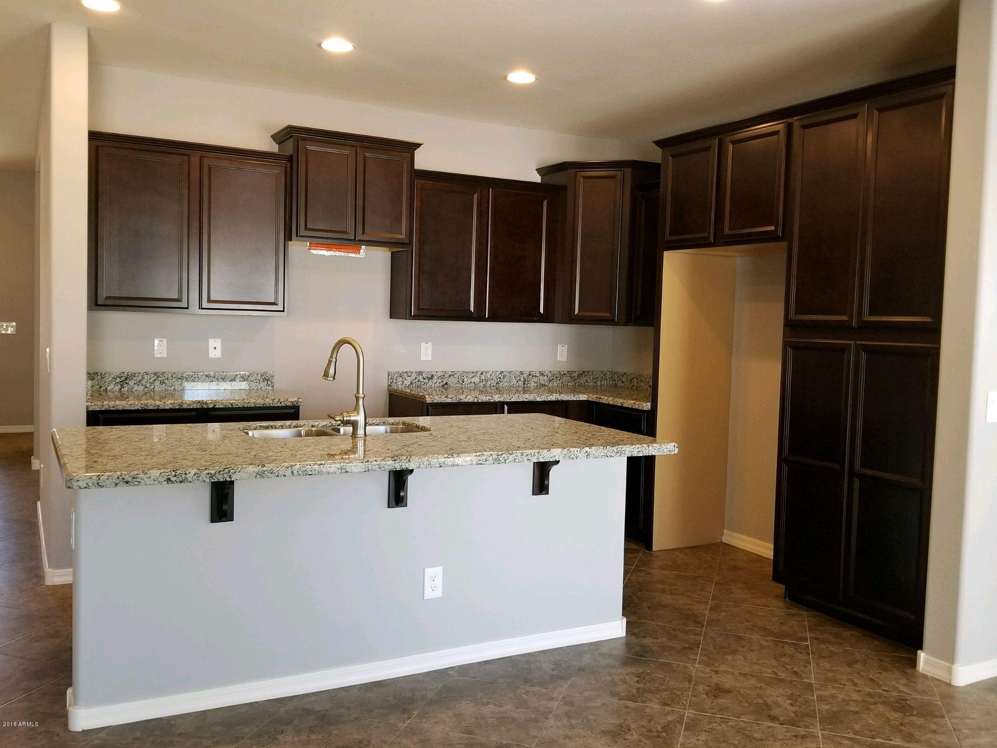 16746 West Rowel Road Surprise, AZ 85387 - Photo 14 of 35 a kitchen with stainless steel appliances granite countertop a refrigerator and a sink
