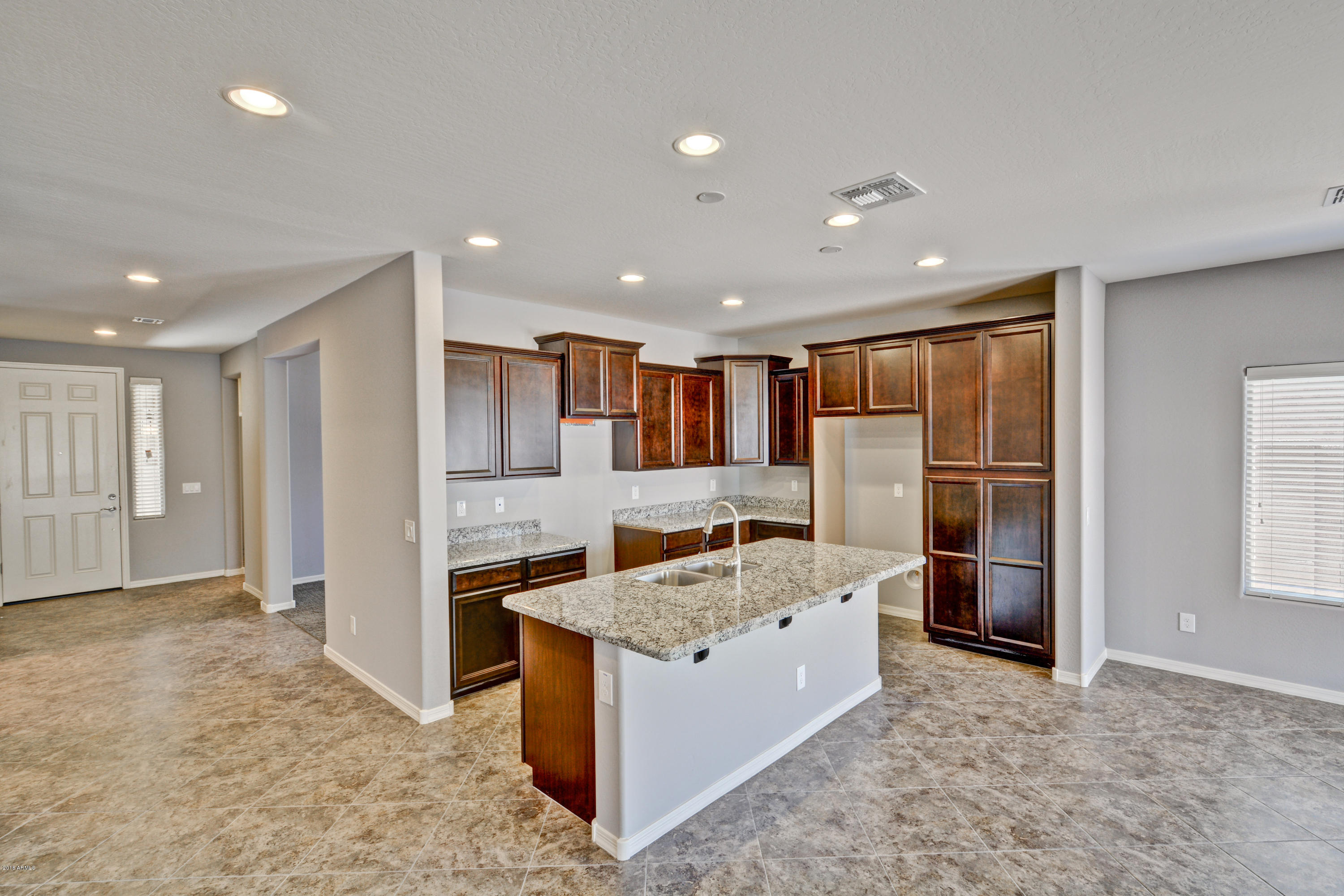 16746 West Rowel Road Surprise, AZ 85387 - Photo 15 of 35 a kitchen with stainless steel appliances granite countertop a refrigerator and a sink