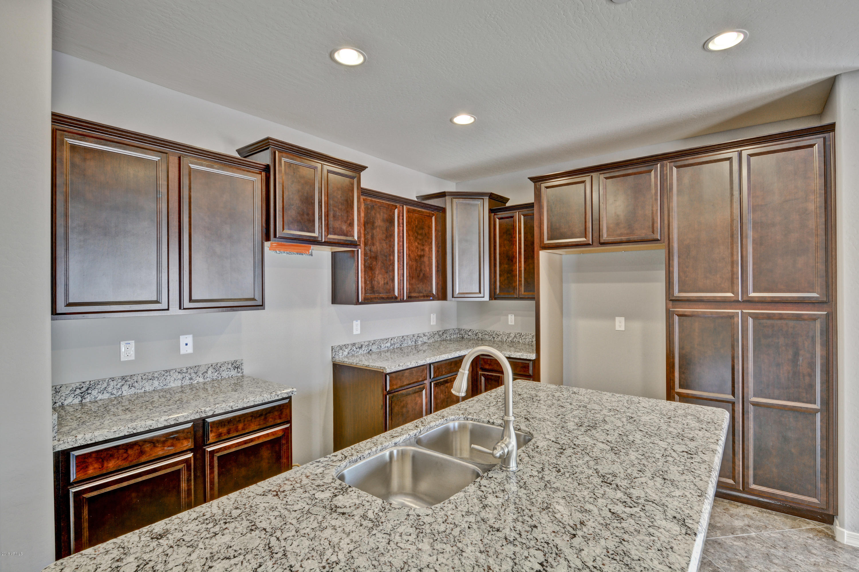 16746 West Rowel Road Surprise, AZ 85387 - Photo 16 of 35 a kitchen with stainless steel appliances granite countertop a refrigerator and a sink