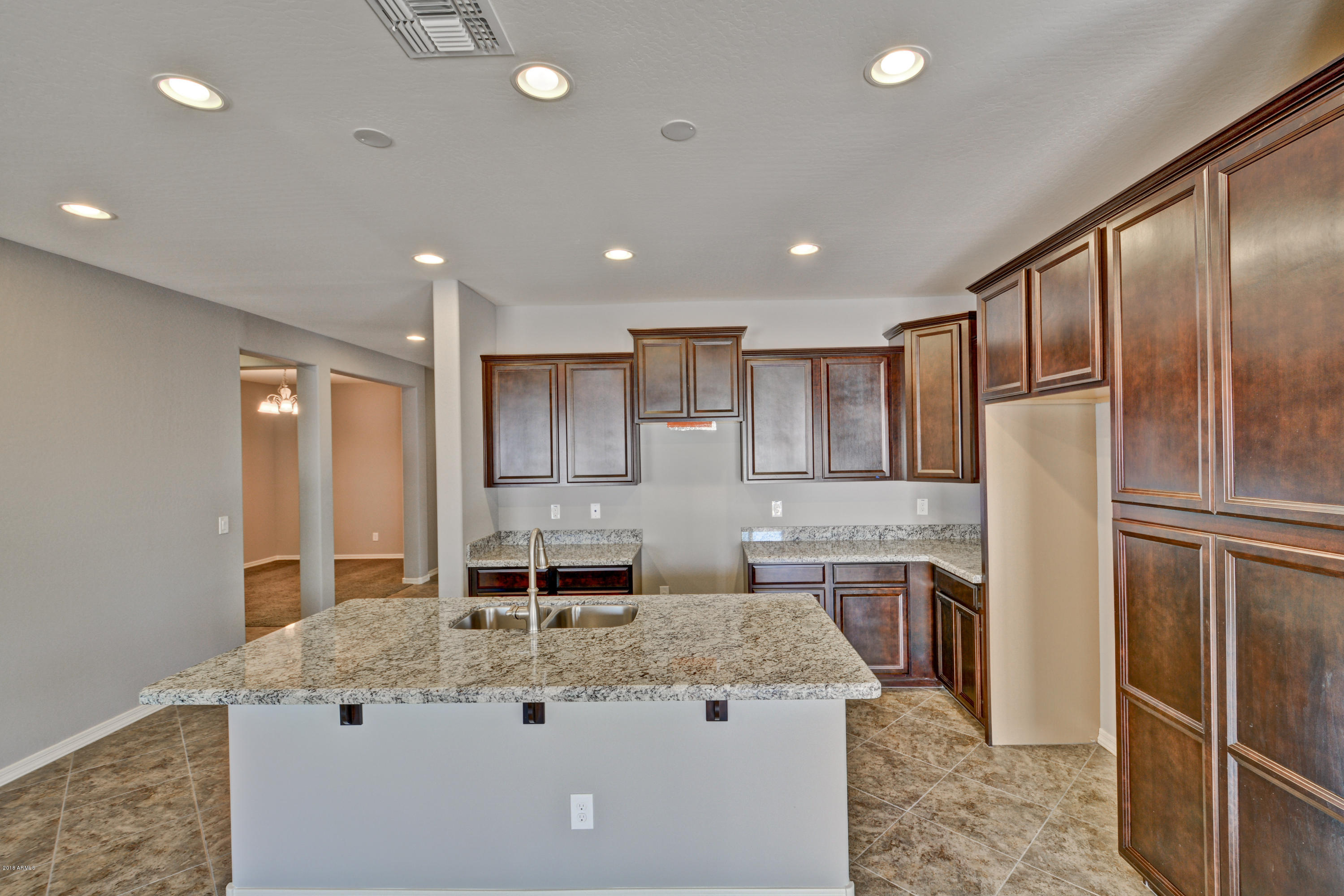16746 West Rowel Road Surprise, AZ 85387 - Photo 17 of 35 a kitchen with stainless steel appliances granite countertop a sink stove and refrigerator