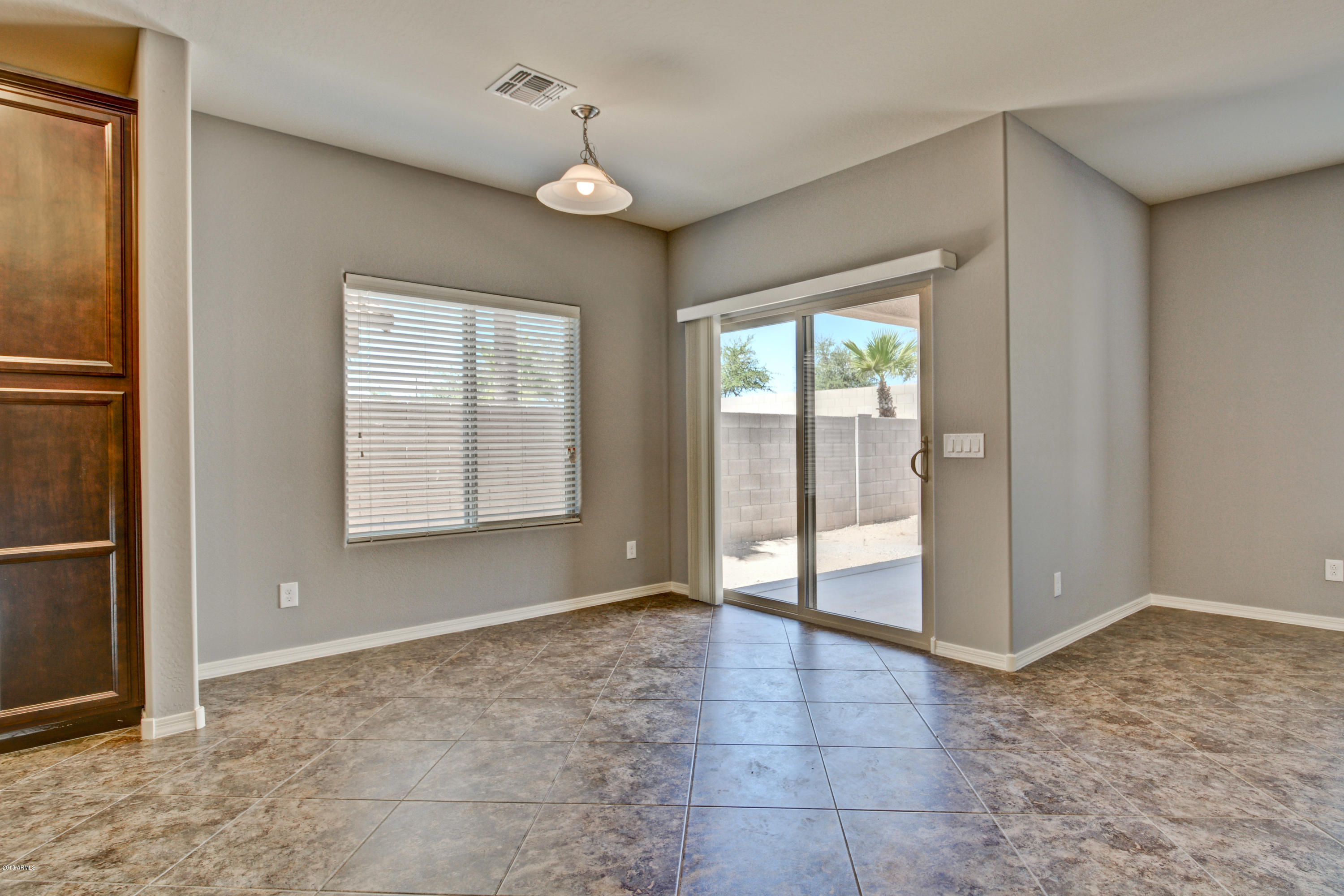 16746 West Rowel Road Surprise, AZ 85387 - Photo 21 of 35 an empty room with windows and closet
