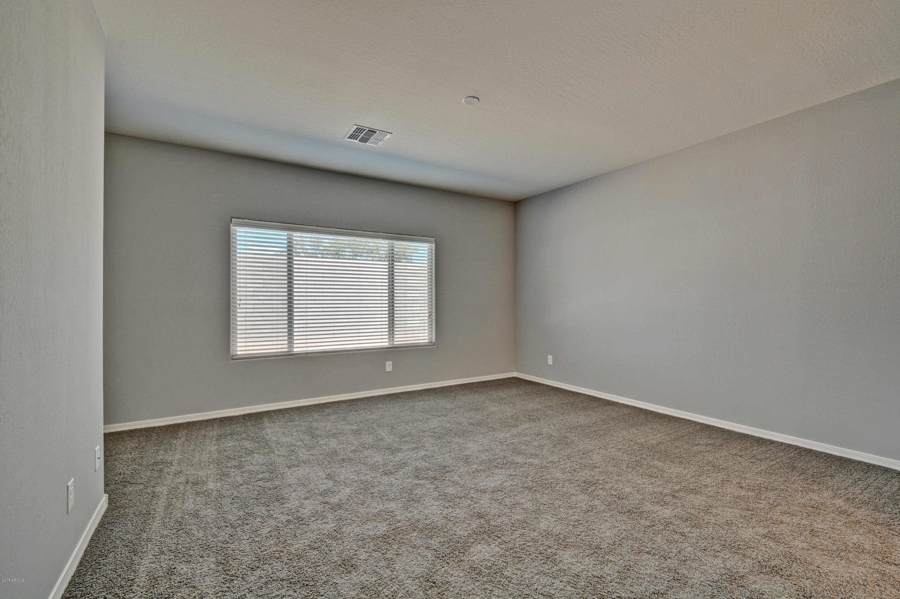 16746 West Rowel Road Surprise, AZ 85387 - Photo 24 of 35 a view of an empty room with a window
