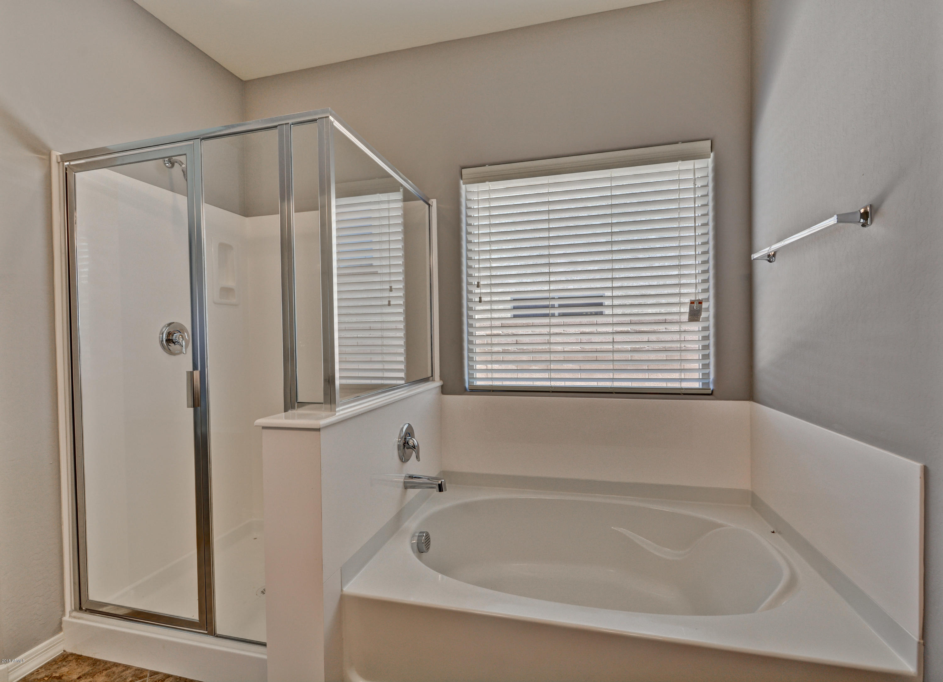 16746 West Rowel Road Surprise, AZ 85387 - Photo 28 of 35 a white bath tub sitting next to a window