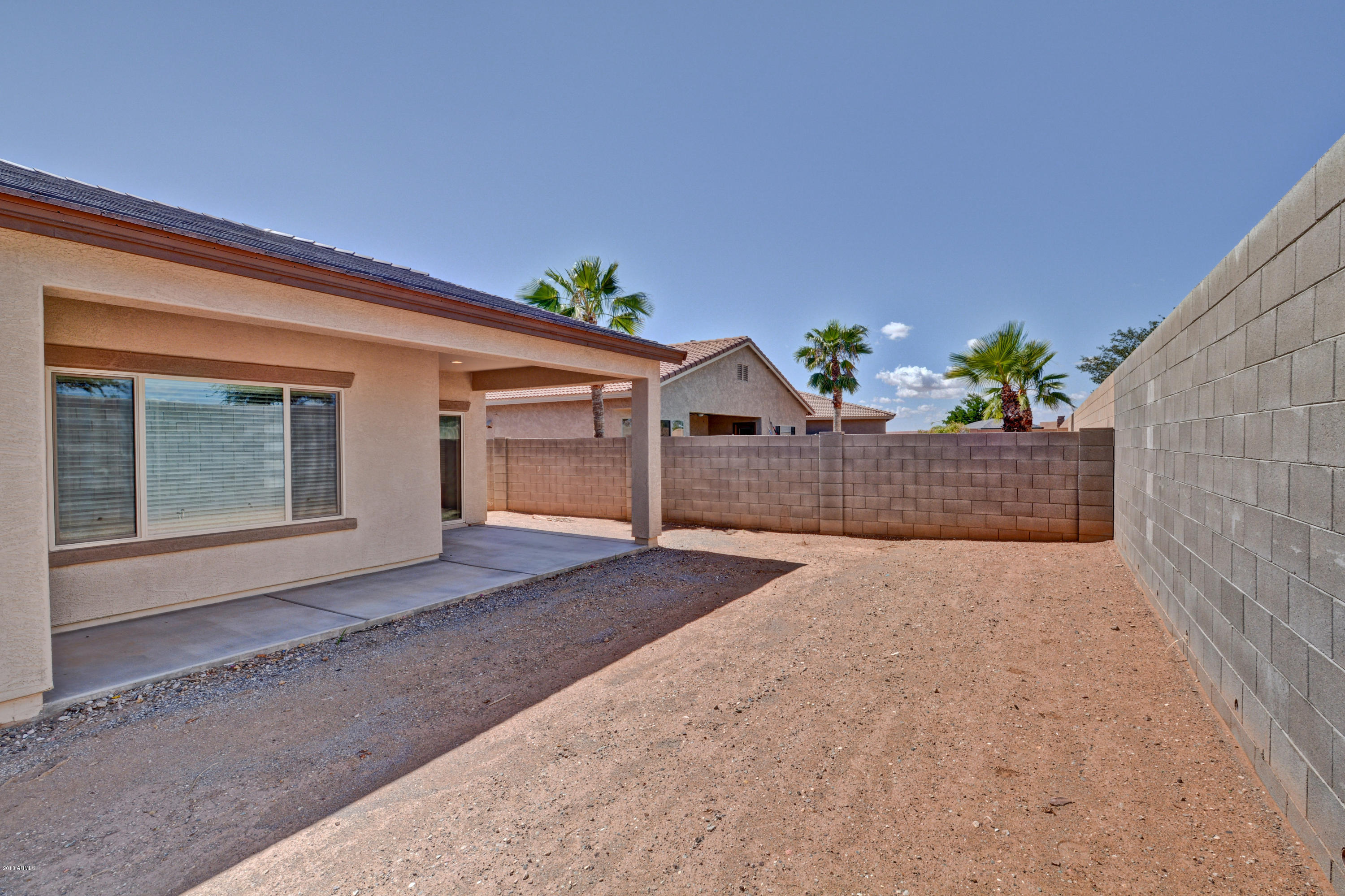 16746 West Rowel Road Surprise, AZ 85387 - Photo 34 of 35 a front view of a house with a yard and a garage