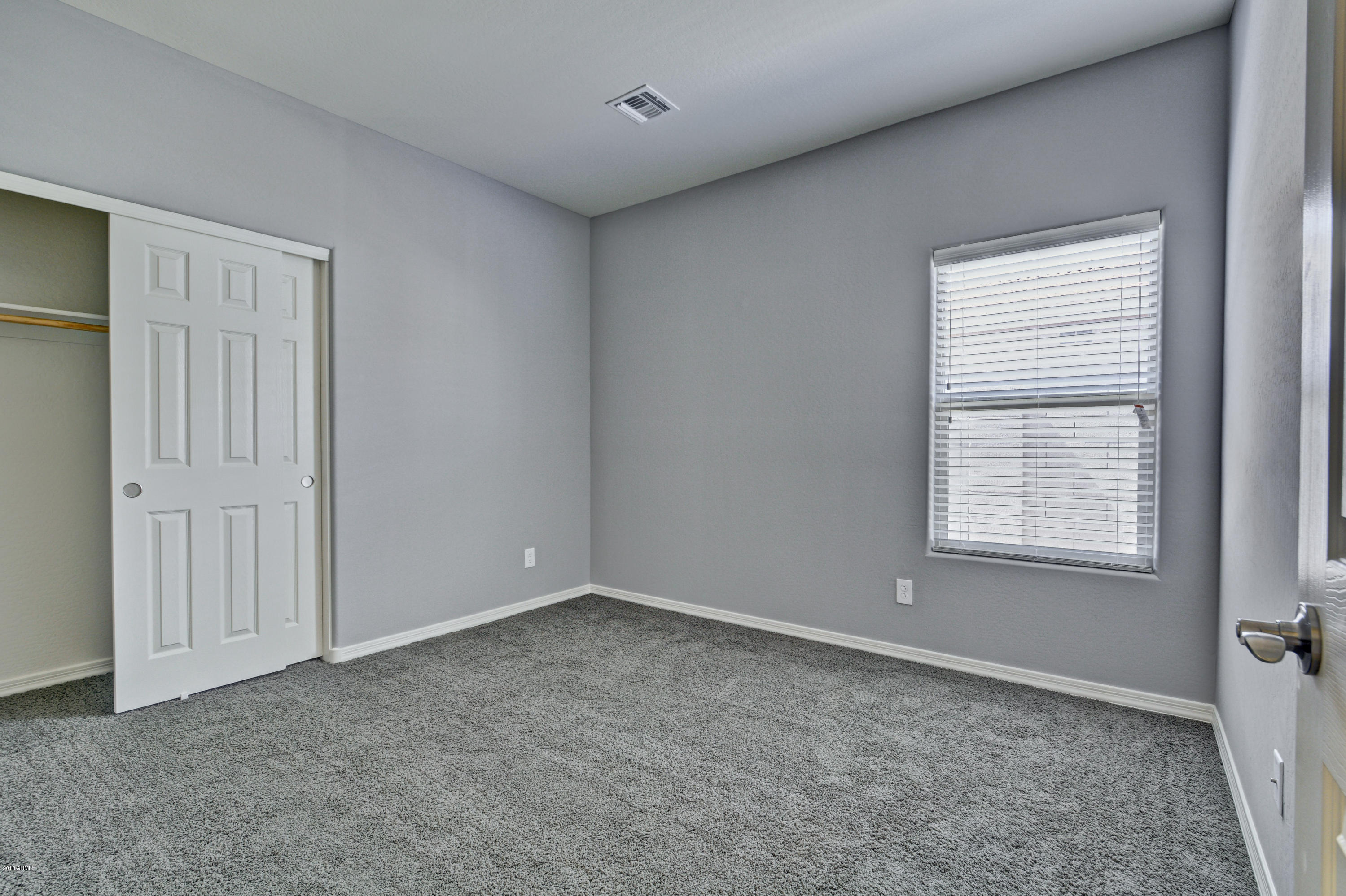 16746 West Rowel Road Surprise, AZ 85387 - Photo 4 of 35 a view of an empty room with a window