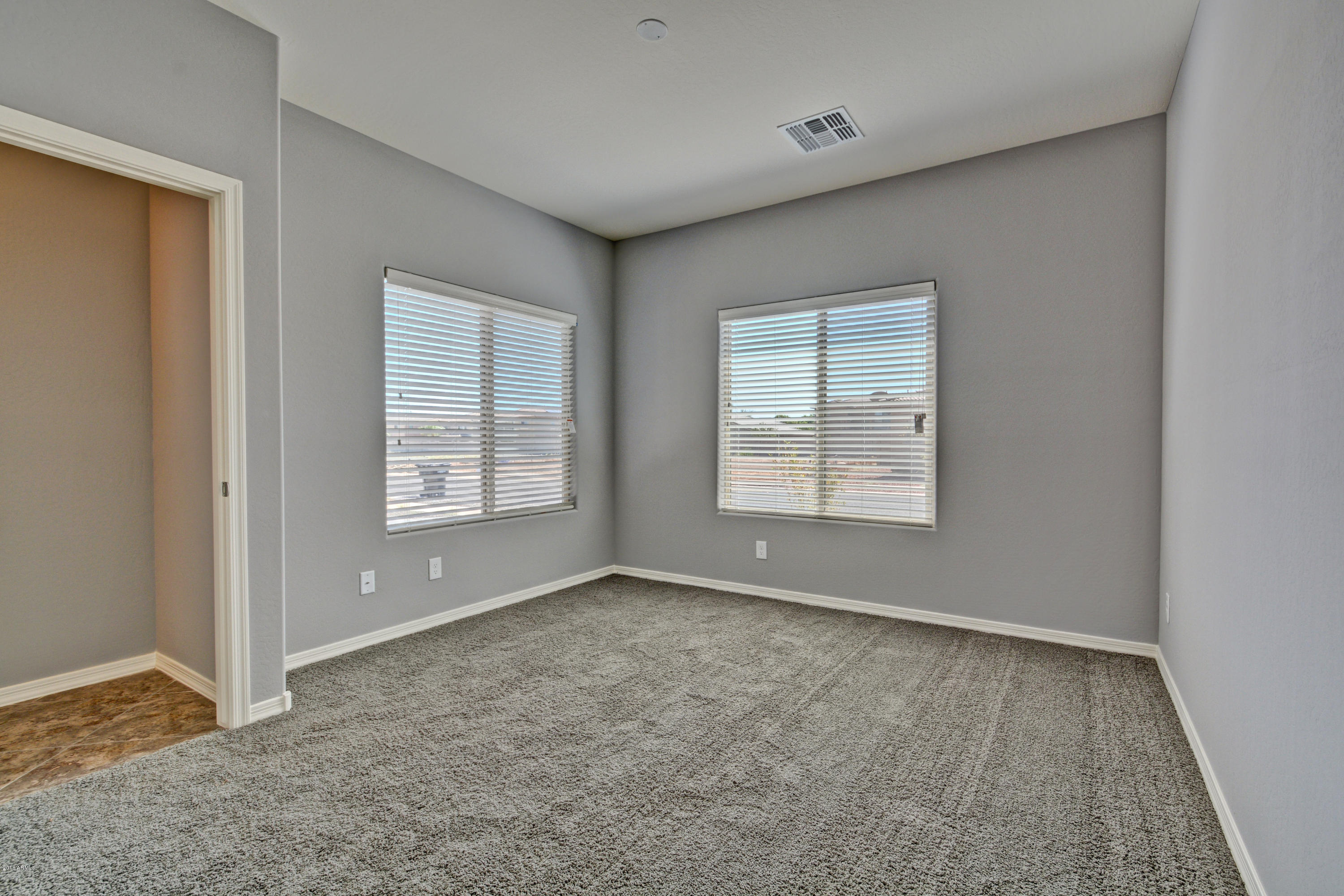 16746 West Rowel Road Surprise, AZ 85387 - Photo 5 of 35 a view of an empty room with a window