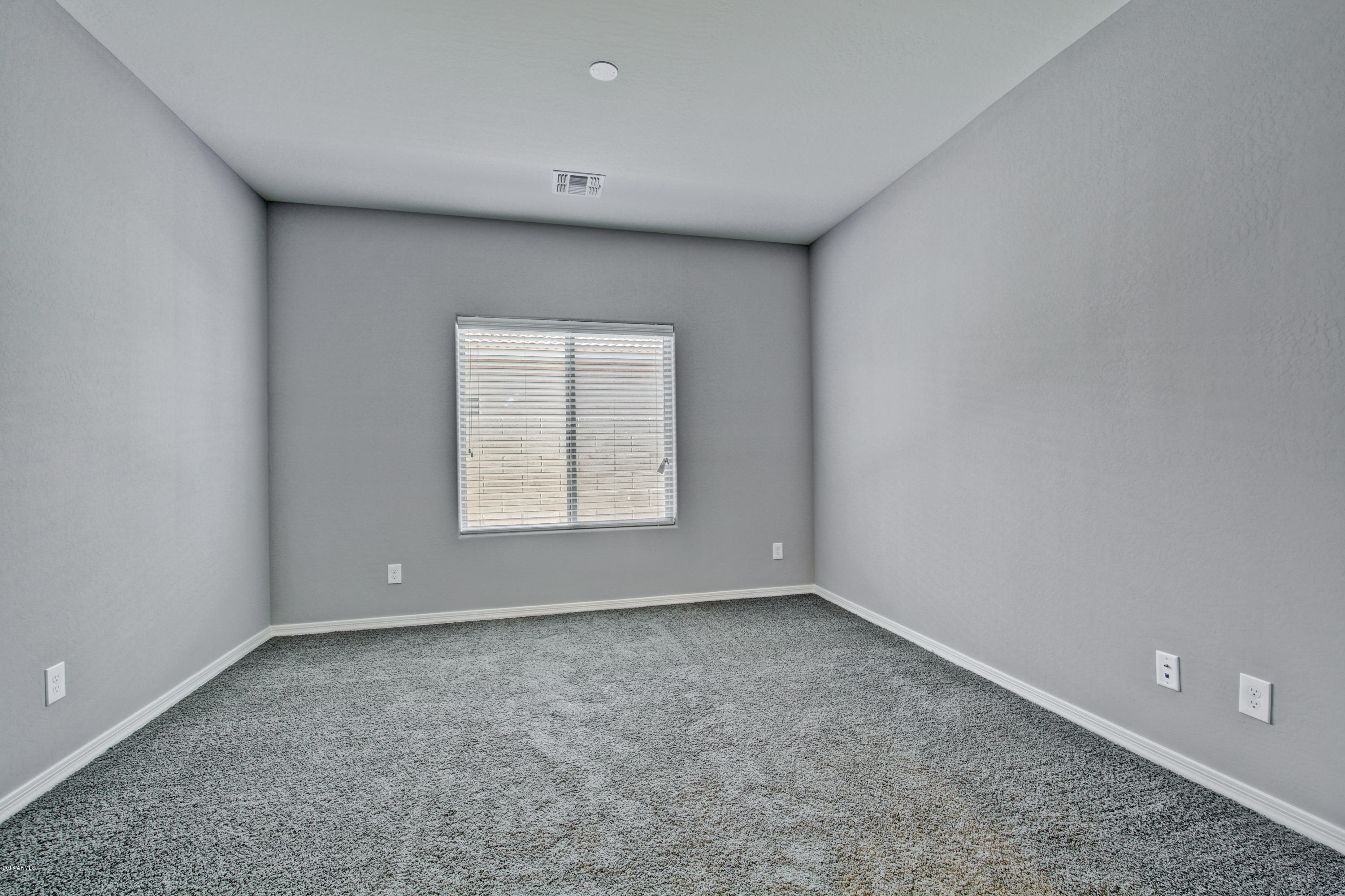 16746 West Rowel Road Surprise, AZ 85387 - Photo 9 of 35 a view of an empty room with a window