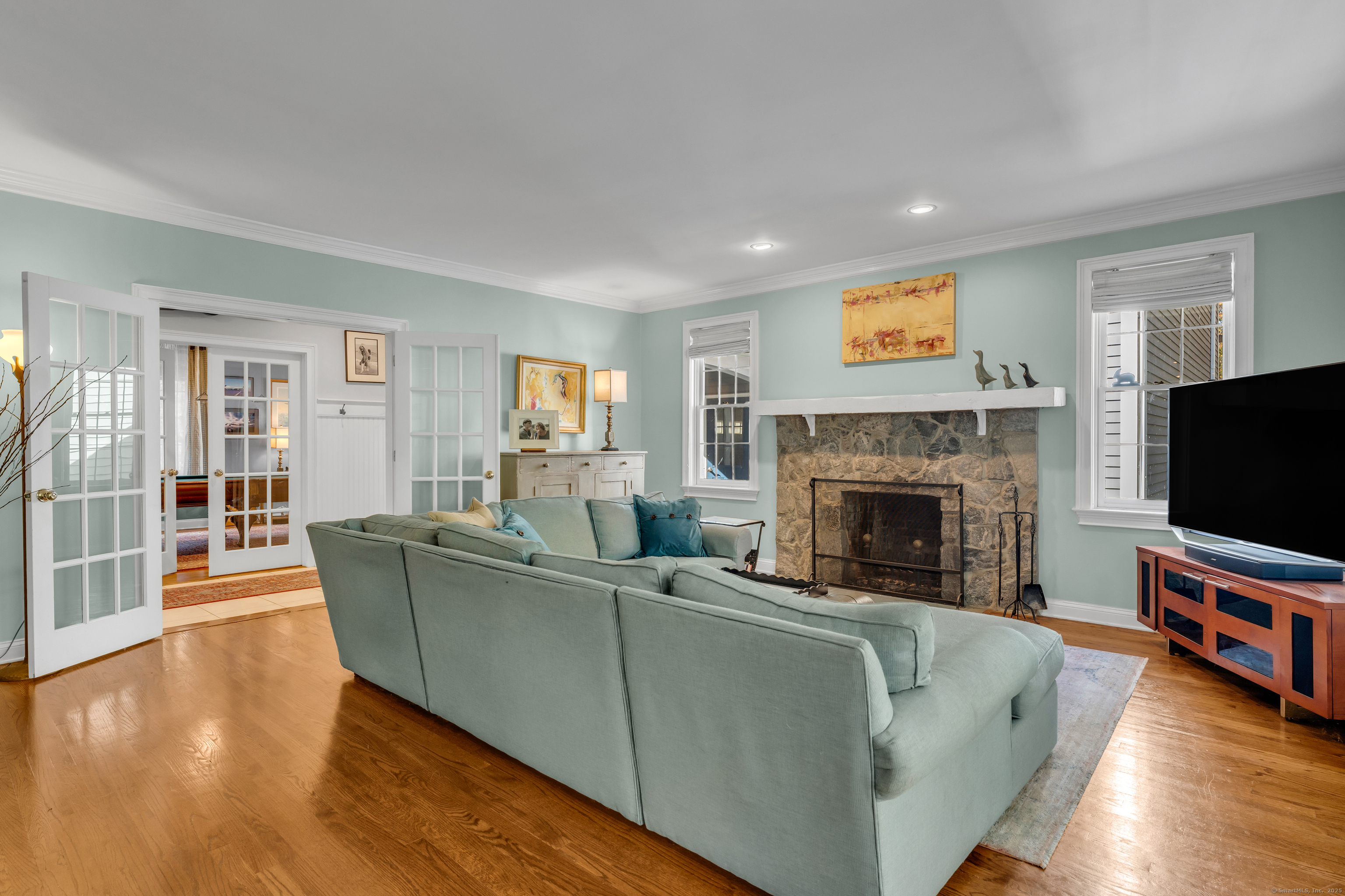 214 Nortontown Road Guilford, CT 06437 - Photo 12 of 40 a living room with furniture a flat screen tv and a fireplace