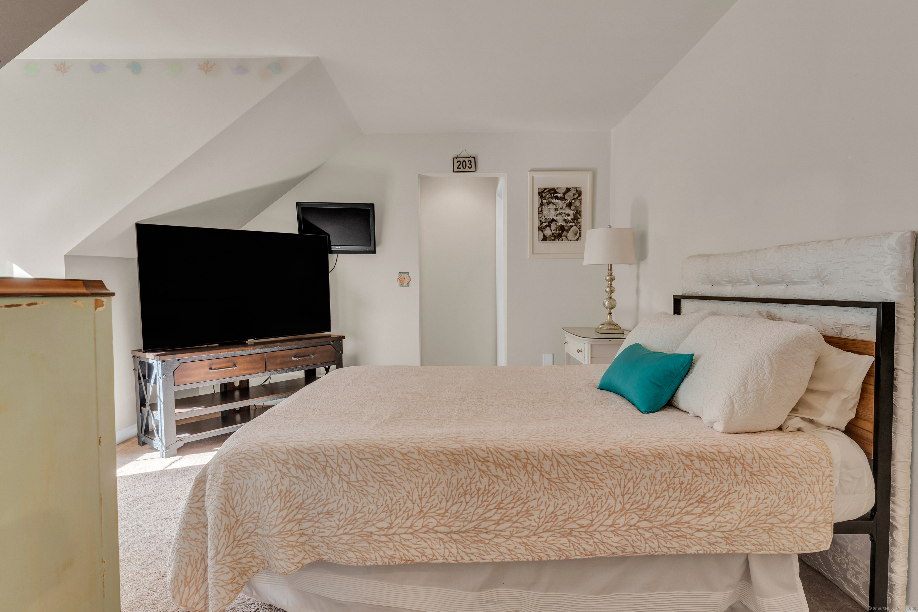 214 Nortontown Road Guilford, CT 06437 - Photo 27 of 40 a bedroom with a bed and a flat screen tv