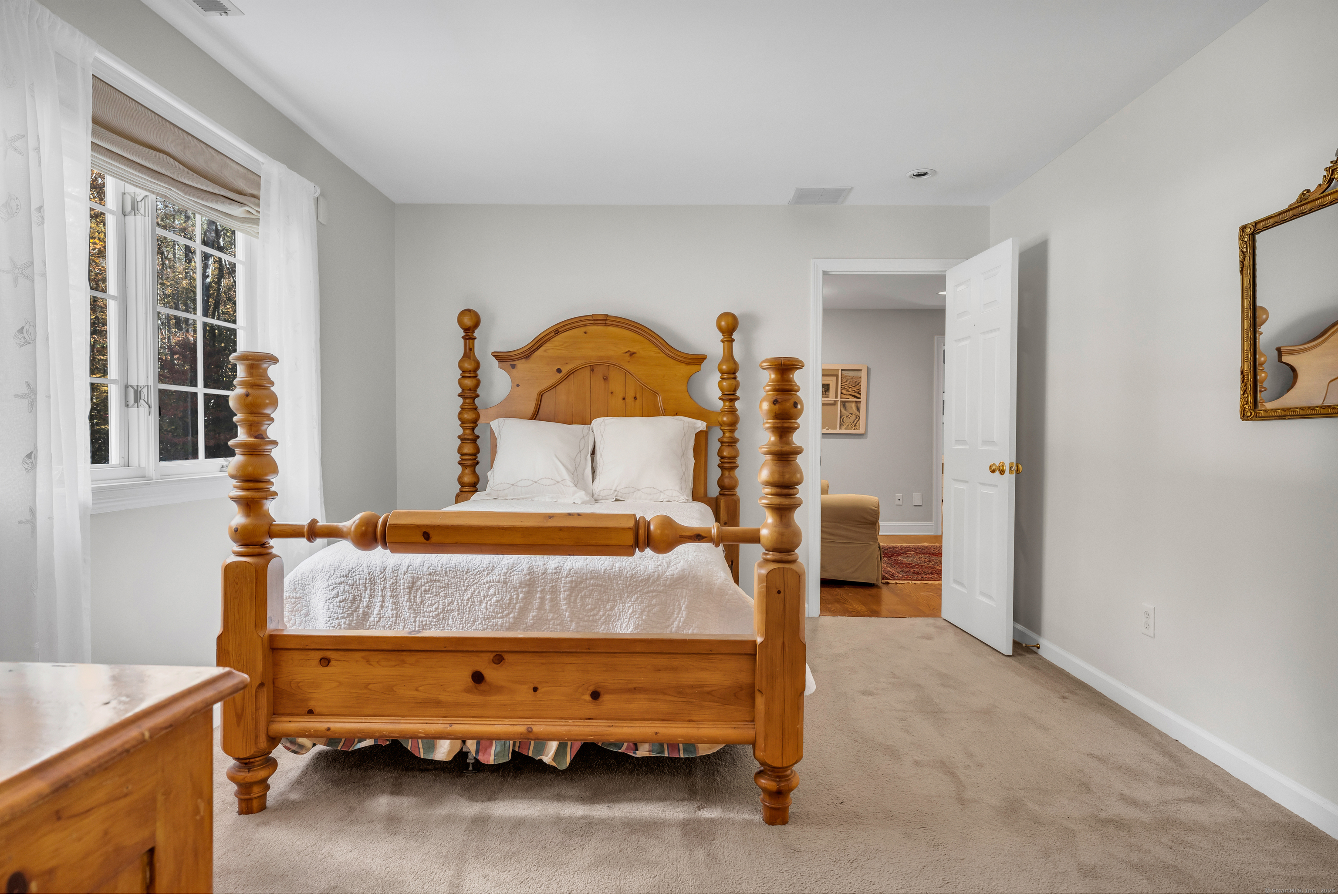 214 Nortontown Road Guilford, CT 06437 - Photo 29 of 40 a bed sitting in a room next to a window