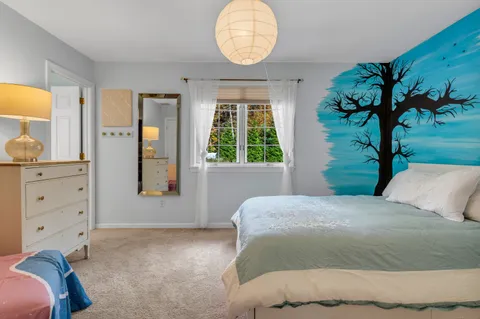 a bedroom with a bed and a potted plant