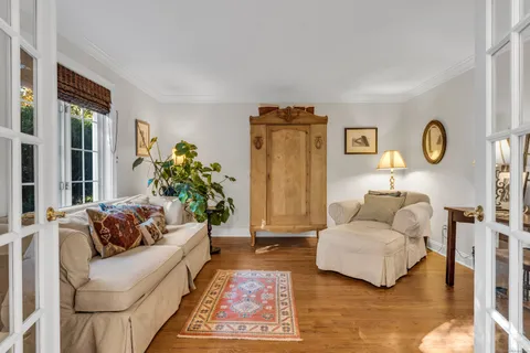 a living room with furniture and wooden floor