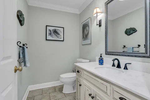 a bathroom with a sink mirror vanity and toilet