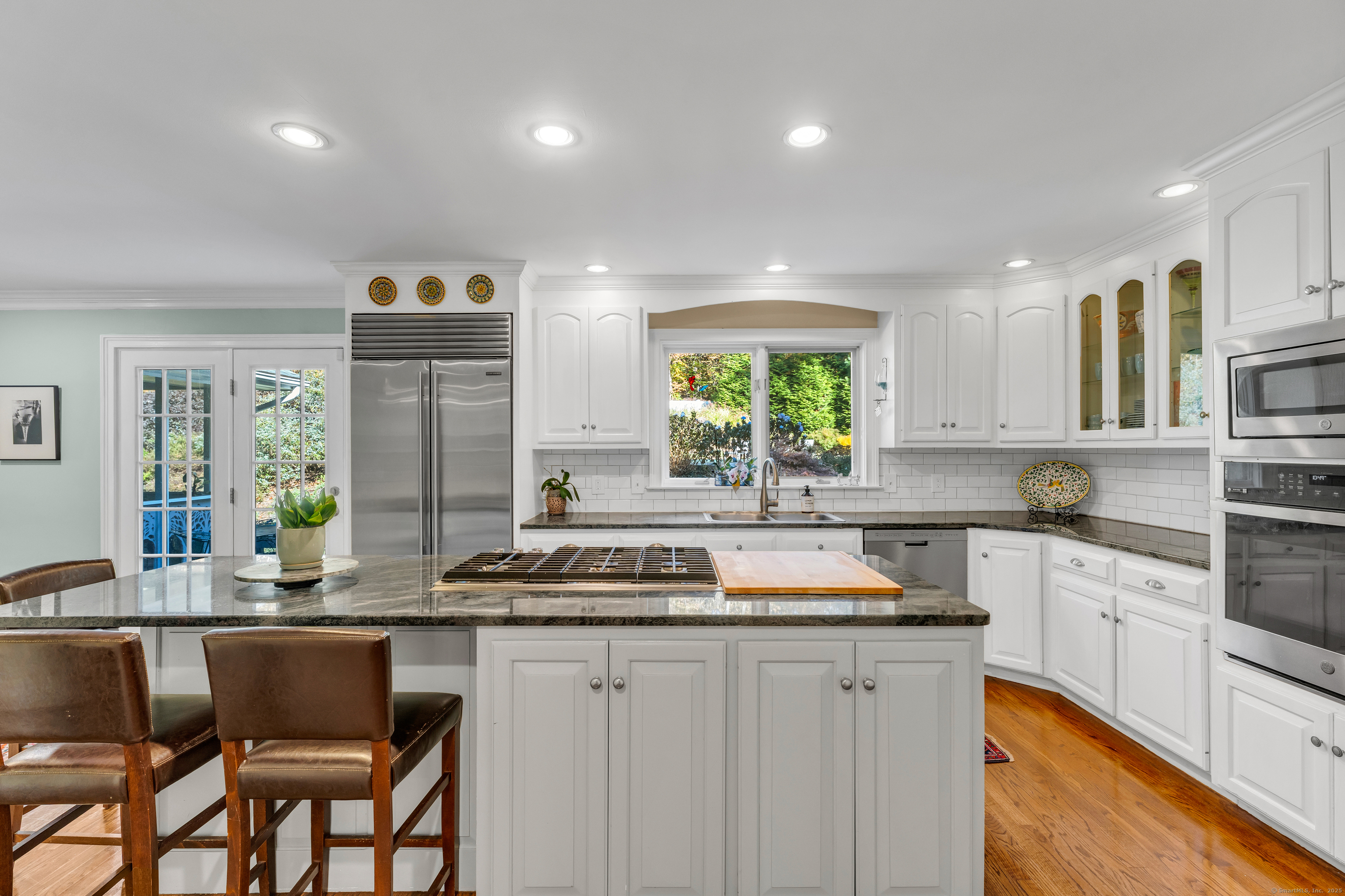214 Nortontown Road Guilford, CT 06437 - Photo 10 of 40 a kitchen with a sink stove and cabinets