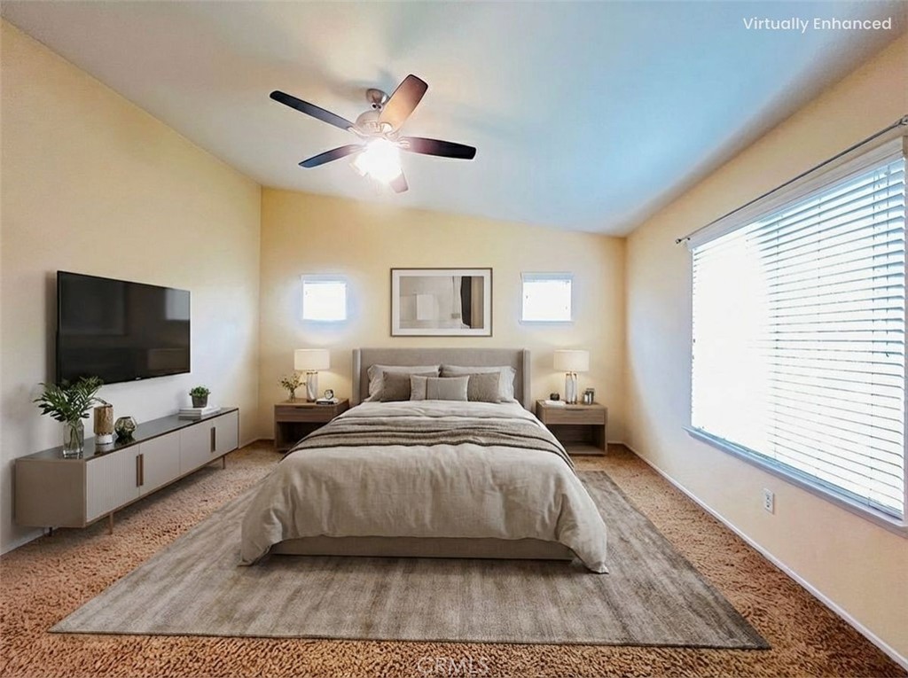 12270 Mesa Grove Drive Riverside, CA 92503 - Photo 23 of 41 a spacious bedroom with a bed and flat screen tv