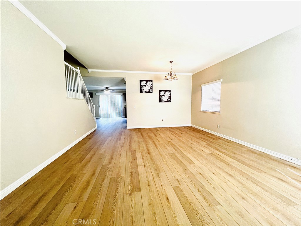 12270 Mesa Grove Drive Riverside, CA 92503 - Photo 6 of 41 a view of a room with wooden floor and staircase