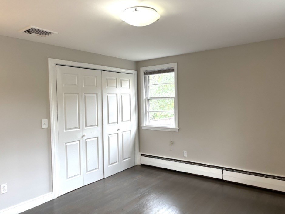 338 Langley Road Newton, MA 02459 - Photo 12 of 18 an empty room with wooden floor and windows