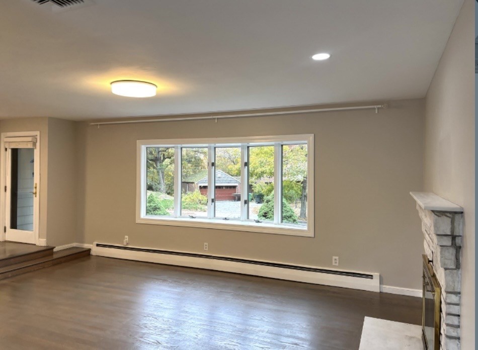 338 Langley Road Newton, MA 02459 - Photo 8 of 18 an empty room with wooden floor and windows