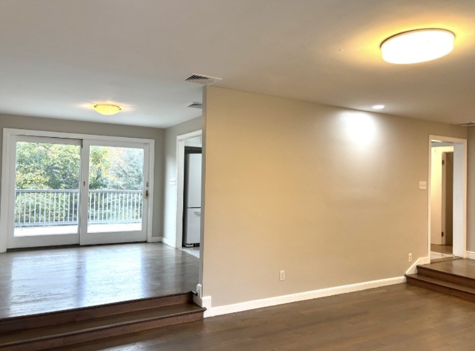 338 Langley Road Newton, MA 02459 - Photo 9 of 18 an empty room with wooden floor and windows