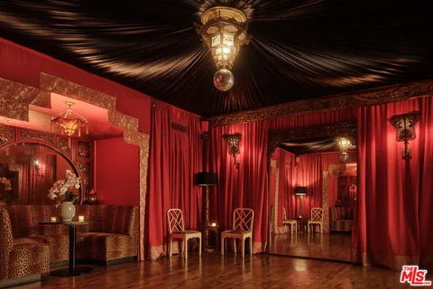 a view of a room with furniture and wooden floor