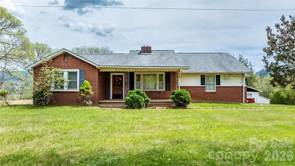 a front view of a house with yard and green space