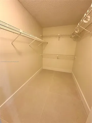 a room with walk in closet and a window