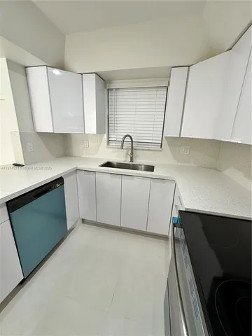 a kitchen with a sink cabinets and appliances