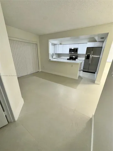 a view of a kitchen with microwave and cabinets