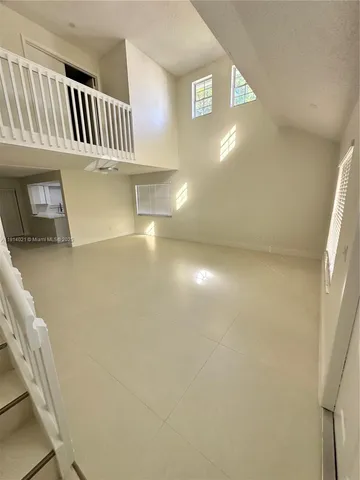 a view of an empty room with windows