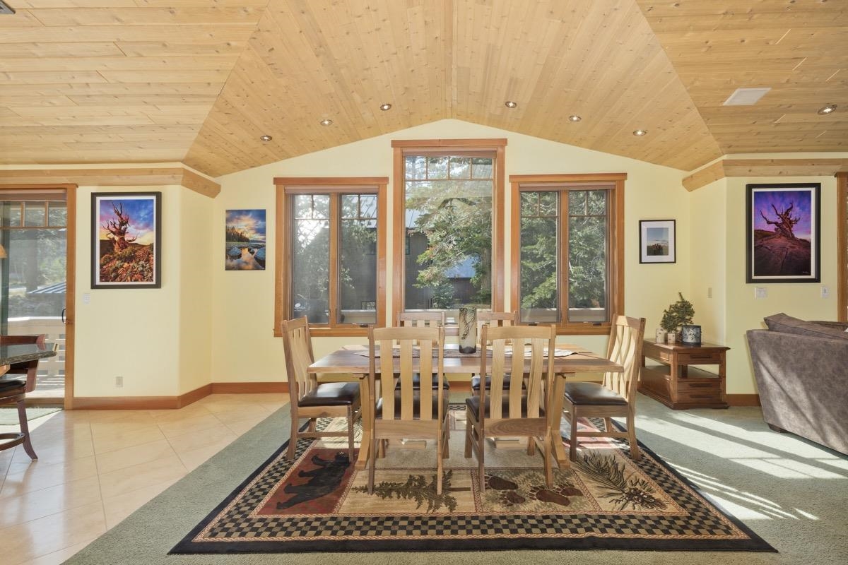 2500 Old Mammoth Road Mammoth Lakes, CA 93546 - Photo 14 of 48 a dining room with wooden floor a rug and a floor to ceiling window