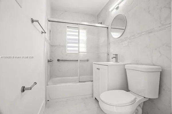 a white toilet sitting next to a bath tub shower