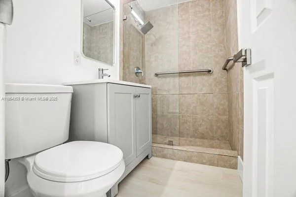 a bathroom with a toilet and a shower